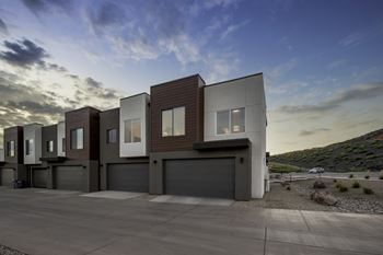 A modern building with a flat roof and garage doors.